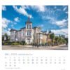 Eine Usedom - PostkartenKalender 2025-Seite für April mit einer sonnigen Straßenansicht eleganter weißer Gebäude mit ausgeprägter europäischer Architektur, darunter ein Turm, in der Stadt auf der Insel Usedom.